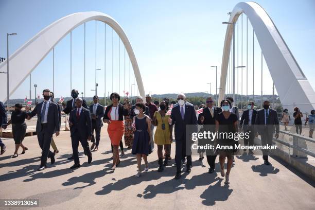 Mayor Muriel Bowser leads lawmakers and descendants of Frederick Douglass along the new Frederick Douglass Memorial Bridge for a ribbon-cutting...