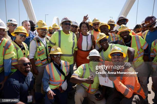 Mayor Muriel Bowser poses for a photo with construction workers after a ribbon-cutting ceremony for the new Frederick Douglass Memorial Bridge on...