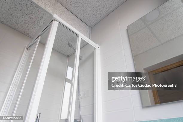 shower and ceiling of small toilet - low angle view room stock pictures, royalty-free photos & images