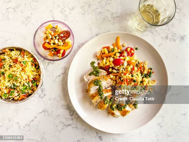 chicken breast, fried rice, and salad on a plate on white, marble background - plate fotografías e imágenes de stock