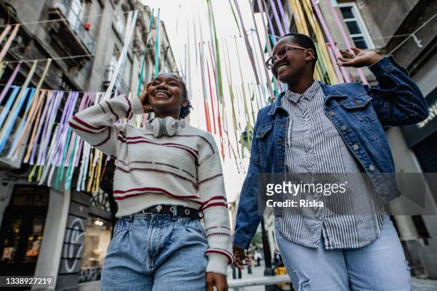 Low angle view of two happy young woman in the city