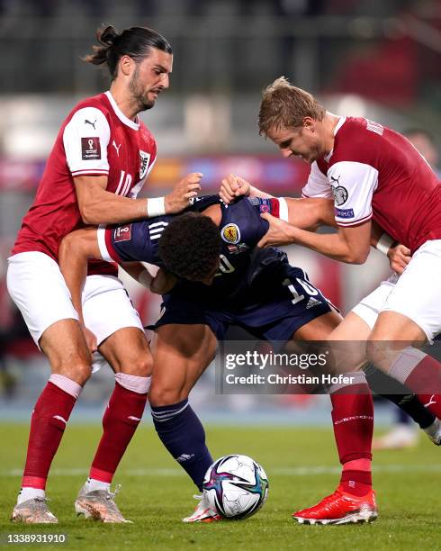 Che Adams of Scotland is fouled by Florian Grillitsch and Martin Hinteregger of Austria leading to a penalty being awarded during the 2022 FIFA World...