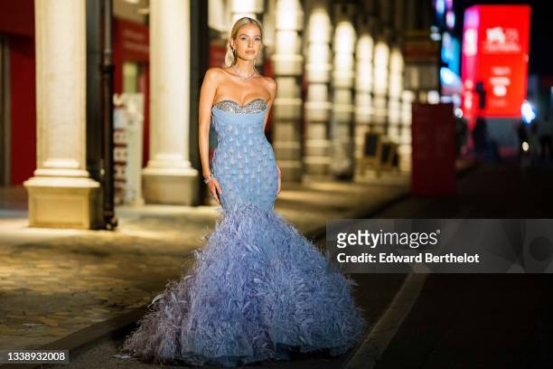 Leonie Hanne wears a bejeweled necklace, earrings, an off-shoulder blue party bustier dress from Rami Kadi with embroidered jewelry, tulle, mesh,...