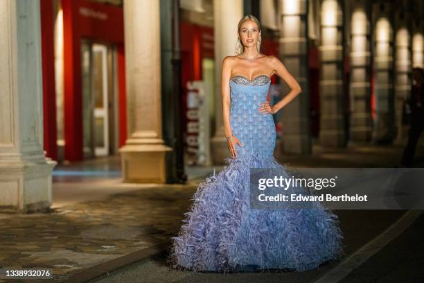 Leonie Hanne wears a bejeweled necklace, earrings, an off-shoulder blue party bustier dress from Rami Kadi with embroidered jewelry, tulle, mesh,...