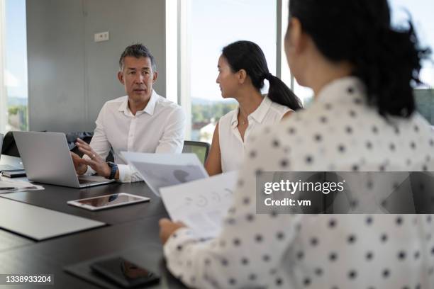 japanese businessman and businesswoman meeting their business partner - financial analyst 個照片及圖片檔