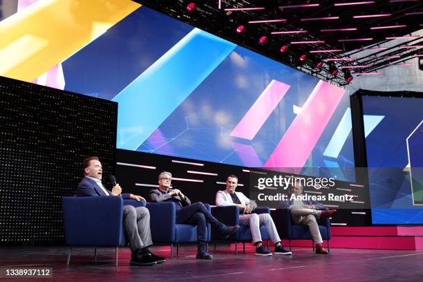 Arnold Schwarzenegger, Gabor Steingart, Wladimir Klitschko and Hagen Rickmann, Director Business Telekom Deutschland GmbH speak on stage during the...