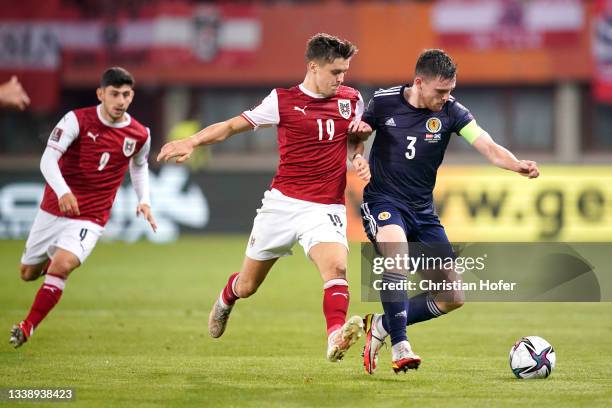 Andy Robertson of Scotland is challenged by Christoph Baumgartner of Austria during the 2022 FIFA World Cup Qualifier match between Austria and...