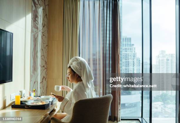 lady eating breakfast in the hotel room - hotel breakfast bildbanksfoton och bilder