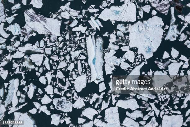 drone shot looking down on a melting ice sheet at the edge of a glacier, iceland - sheet of ice stock pictures, royalty-free photos & images