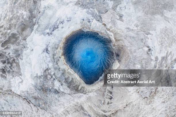 close up drone shot showing a vivid coloured geothermal hot spring, iceland - geyser ストックフォトと画像
