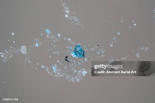 melting pieces of ice floating in glacial meltwater photographed by drone, iceland - ice sheet stock pictures, royalty-free photos & images