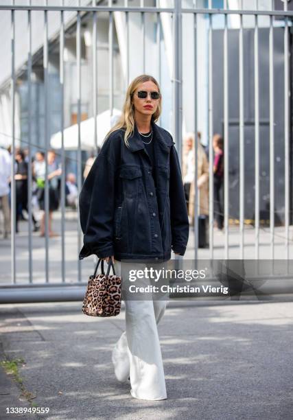 Cheyenne Tulsa seen wearing dark denim jacket, bag with leopard print, white pants outside Fassbender during Fashion Week Berlin on September 07,...