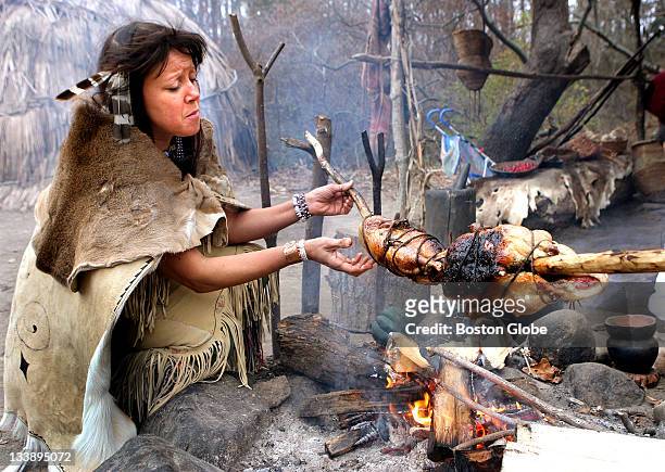 Kitty Hendricks-Miller of Mashpee, a Wompanoag native-American, turns ducks on a spit during a recreation at Plimoth Plantation of a Wompanoag...