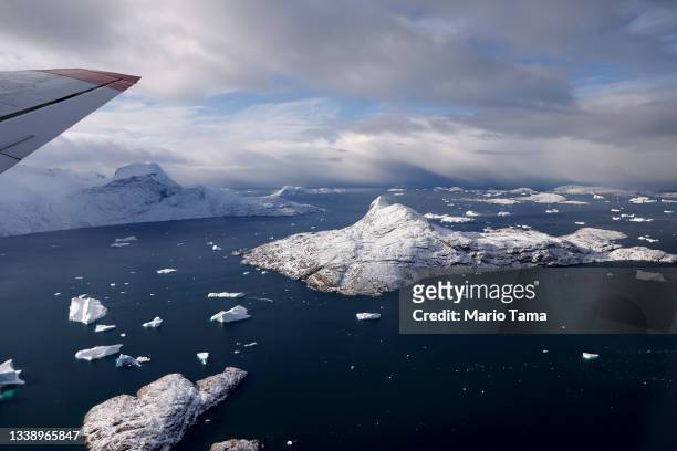 Icebergs float near islands as seen from NASA's Oceans Melting Greenland research aircraft on September 7, 2021 near Upernavik, Greenland. The NASA...