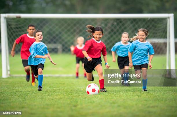 children in a friendly soccer match - kids' soccer stock pictures, royalty-free photos & images