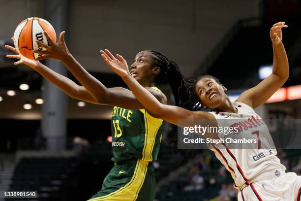 Ezi Magbegor of the Seattle Storm and Ariel Atkins of the Washington Mystics reach for a rebound during the fourth quarter at Angel of the Winds...
