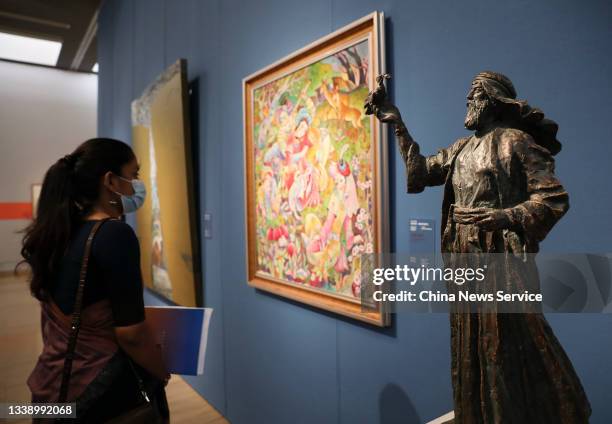 Woman visits the Shanghai Cooperation Organisation Countries Art Exhibition themed on 'For a Shared Dream' at the National Art Museum of China on...