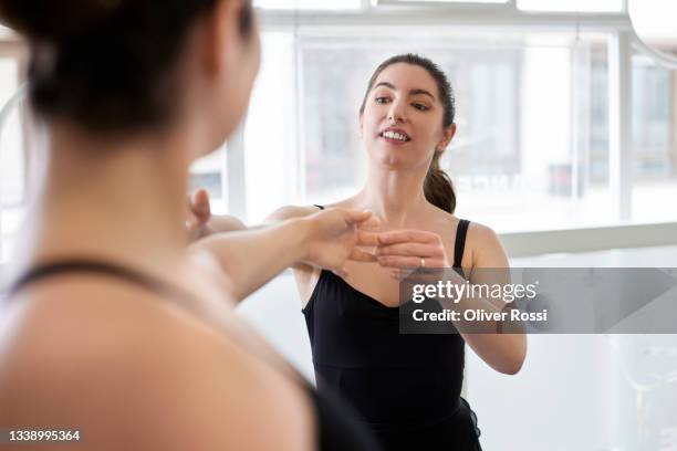 instructor teaching dancer in a ballet studio - dance teacher foto e immagini stock