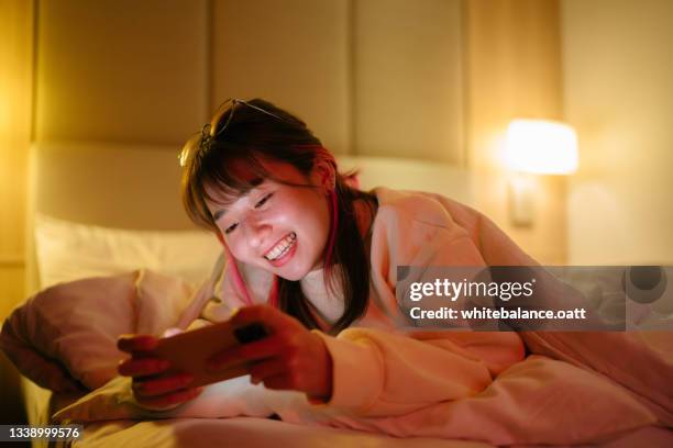 happy woman holding smartphone at home - video reviewed stock pictures, royalty-free photos & images