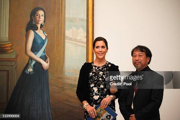 Princess Mary of Denmark and artist Jiawei Shen pose next to a painting of Princess Mary at the Portrait Gallery in Canberra on November 22, 2011 in...