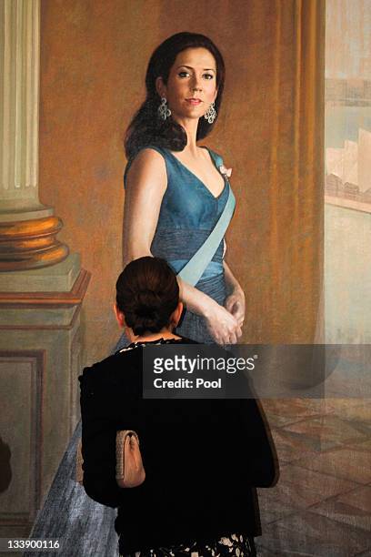 Princess Mary of Denmark inspects a painting of herself created by artist Jiawei Shen at the Portrait Gallery on November 22, 2011 in Canberra,...