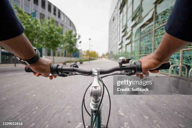 point of view from a businessman cycling to work - point of view stock pictures, royalty-free photos & images