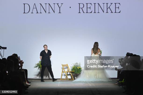 Designer Danny Reinke greets the audience after his show at the Mercedes-Benz Fashion Week Berlin September 2021 at Kraftwerk Mitte on September 08,...