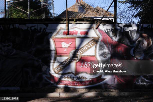 Swindon Town FC mural is seen on a wall outside the stadium prior to the Papa John's Trophy match between Swindon Town and Arsenal U21 at County...