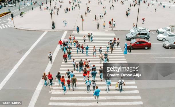 aerial view of a crowd crossing the street - crowd of people from above stock pictures, royalty-free photos & images