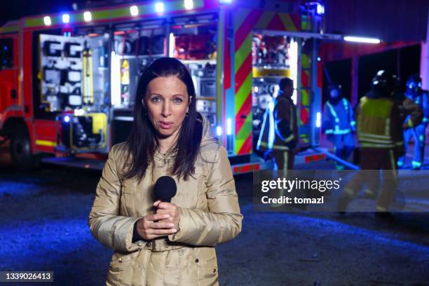 reporter covering the fire - press night imagens e fotografias de stock