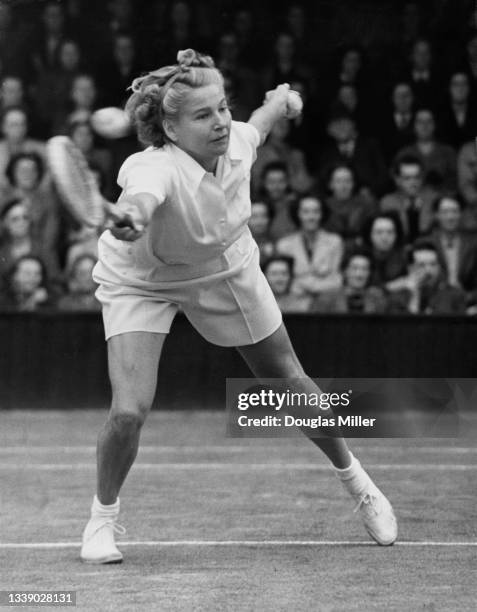 Louise Brough of the United States playing a forehand return to Joan Curry of Great Britain during their Women's Singles match of the 18th edition of...