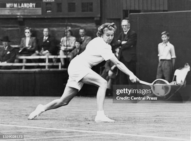 Louise Brough of the United States watches the tennis ball playing a backhand return to Nelly Landry of France during their Women's Singles Second...