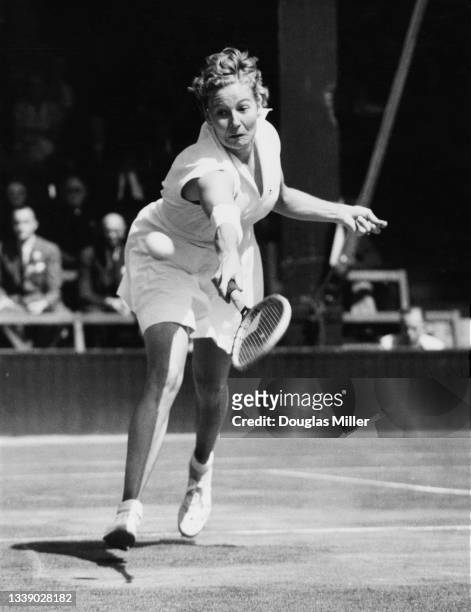 Louise Brough of the United States watches the tennis ball playing a backhand return to Kay Tuckey of Great Britain during their Women's Singles...