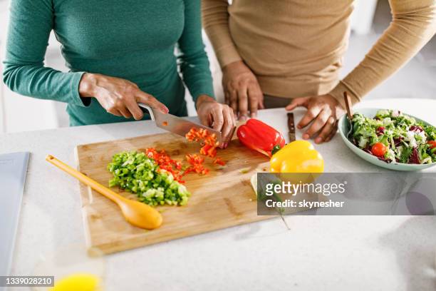 close up of unrecognizable couple cutting bell pepper. - chopping stock pictures, royalty-free photos & images