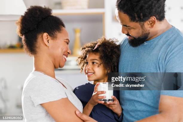 famiglia nera felice che comunica in cucina. - drink milk foto e immagini stock