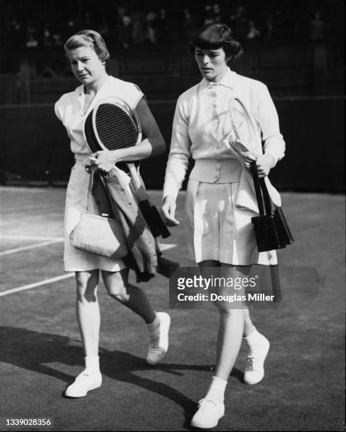 Louise Brough of the United States and compatriot Pat Todd walk onto Centre Court for their Women's Singles Semi Final match at the Wimbledon Lawn...
