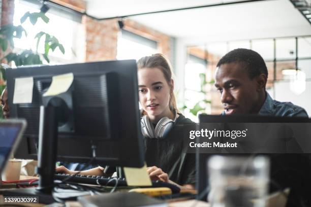 female and male programmers coding on computer at office - software developer stock pictures, royalty-free photos & images