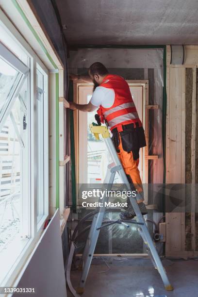Worker Using Ladder Step Ladder Construction Photos and Premium High Res Pictures - Getty ...
