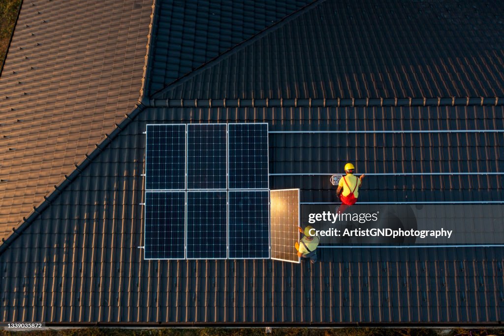 Solar Panel Installation On A Roof Of A House.
