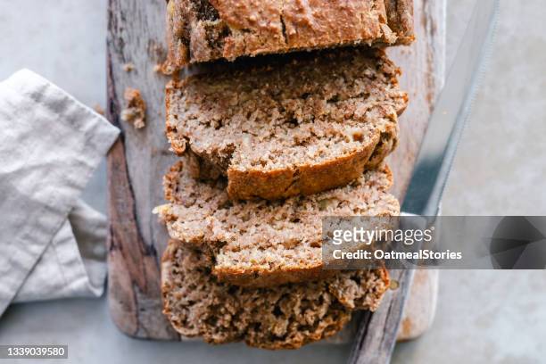 sliced banana bread on a wooden chopping board - sweet bread stock pictures, royalty-free photos & images