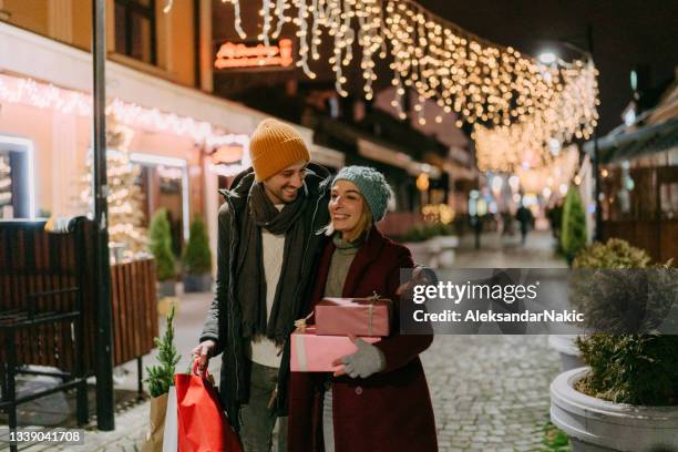 coming back from the christmas shopping - young couple shopping stock pictures, royalty-free photos & images