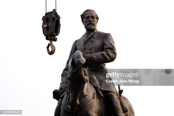 Hook is lowered from a construction crane next to the statue of Robert E. Lee at the Robert E. Lee Memorial prior to its removal September 8, 2021 in...