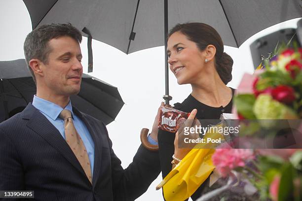 Princess Mary of Denmark shows a package of "TimTams" chocolate cookies to Prince Frederik of Denmark during a visit to the Arboretumon November 22,...