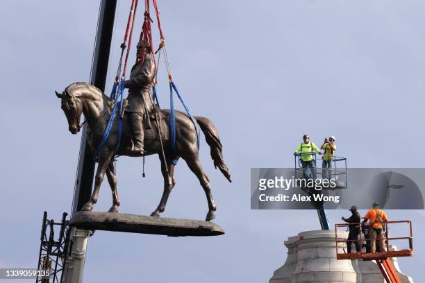 The statue of Robert E. Lee is lowered from its pedestal at Robert E. Lee Memorial during a removal September 8, 2021 in Richmond, Virginia. The...