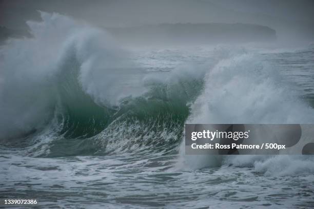 scenic view of sea waves against sky,st clair,dunedin,new zealand - dunedin new zealand stock pictures, royalty-free photos & images