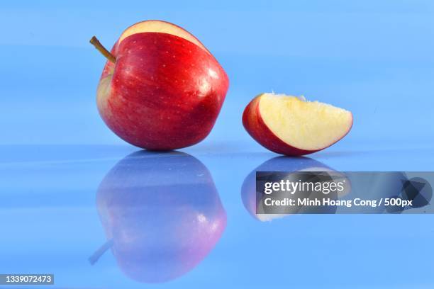close-up of fruits on table against blue background,france - green apple slices stock pictures, royalty-free photos & images
