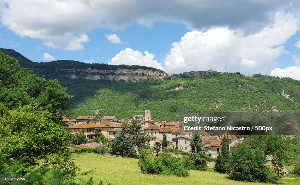 Trees and houses on field against sky,Paggese,Ascoli Piceno,Italy