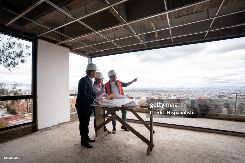 Contractor, architect and engineer working as a team at a construction site