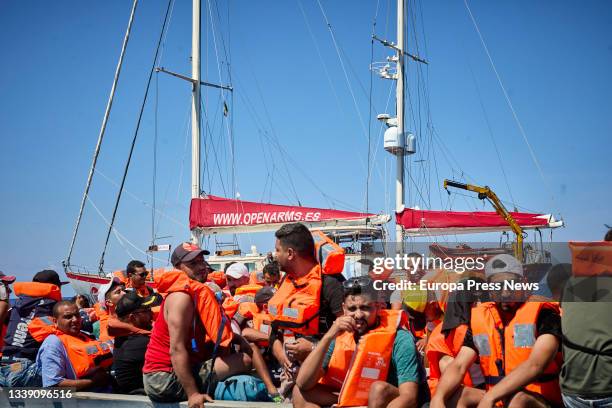 Several of the migrants traveling in a skiff sighted by the NGO Open Arms from the boat 'Astral', on September 8 in the Mediterranean Sea, in the...