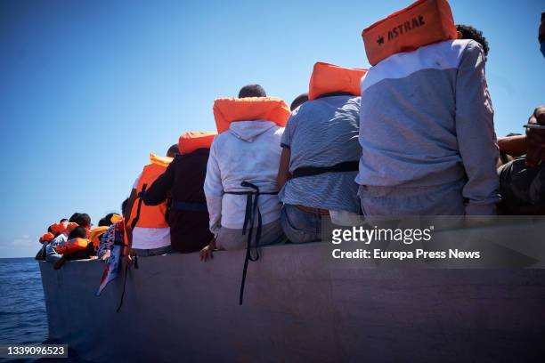 Several of the migrants traveling in a skiff sighted by the NGO Open Arms from the boat 'Astral', on September 8 in the Mediterranean Sea, in the...